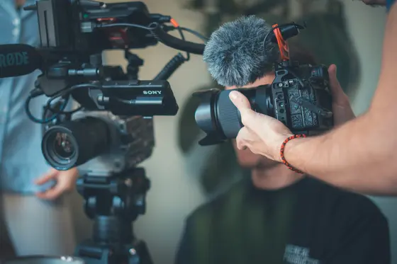 Filmmaker desk with camera gear and monitors (content creation)
